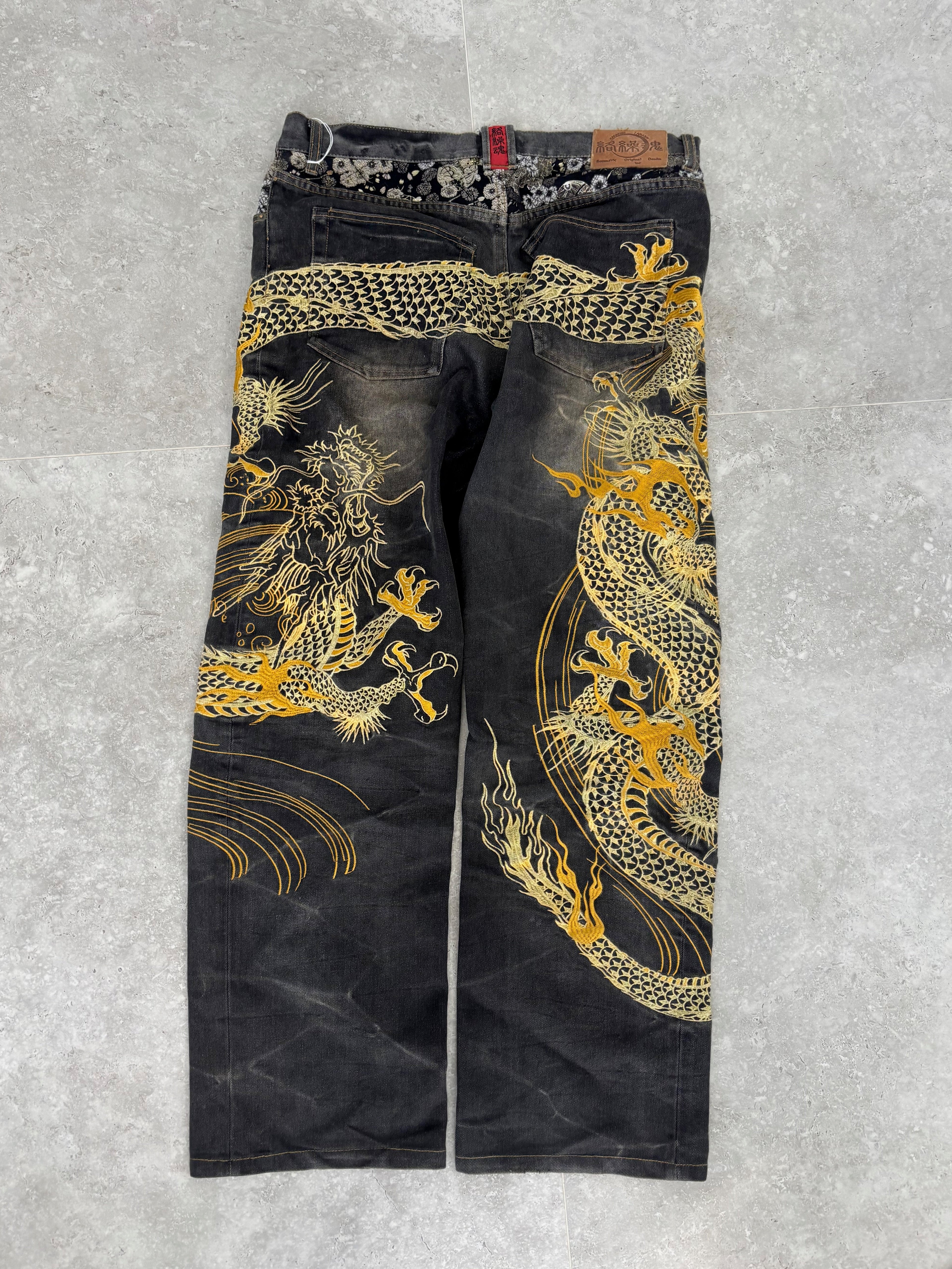 Karakuri black tab jeans with full dragon embroidery. Size 34–36.