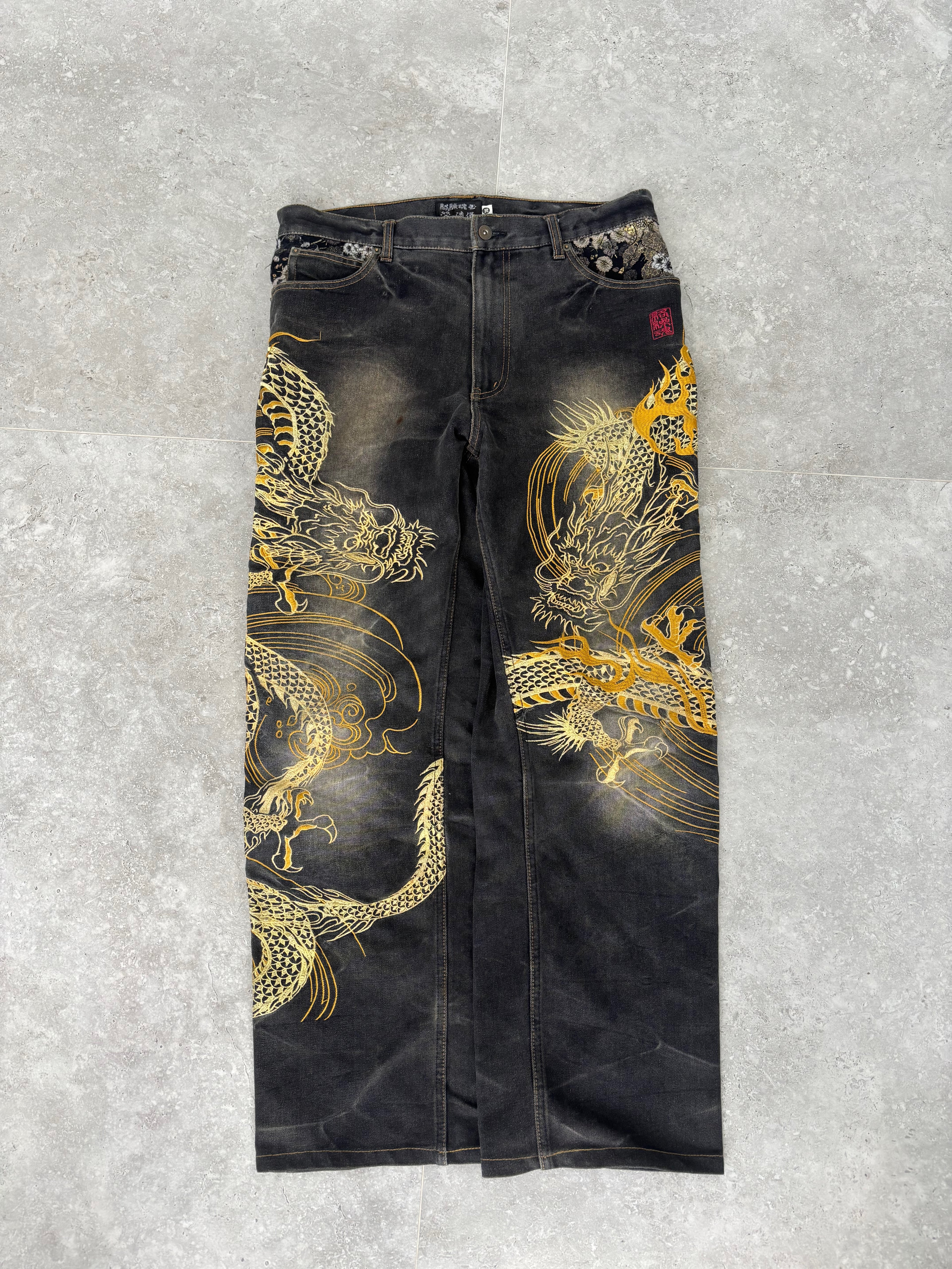 Karakuri black tab jeans with full dragon embroidery. Size 34–36.