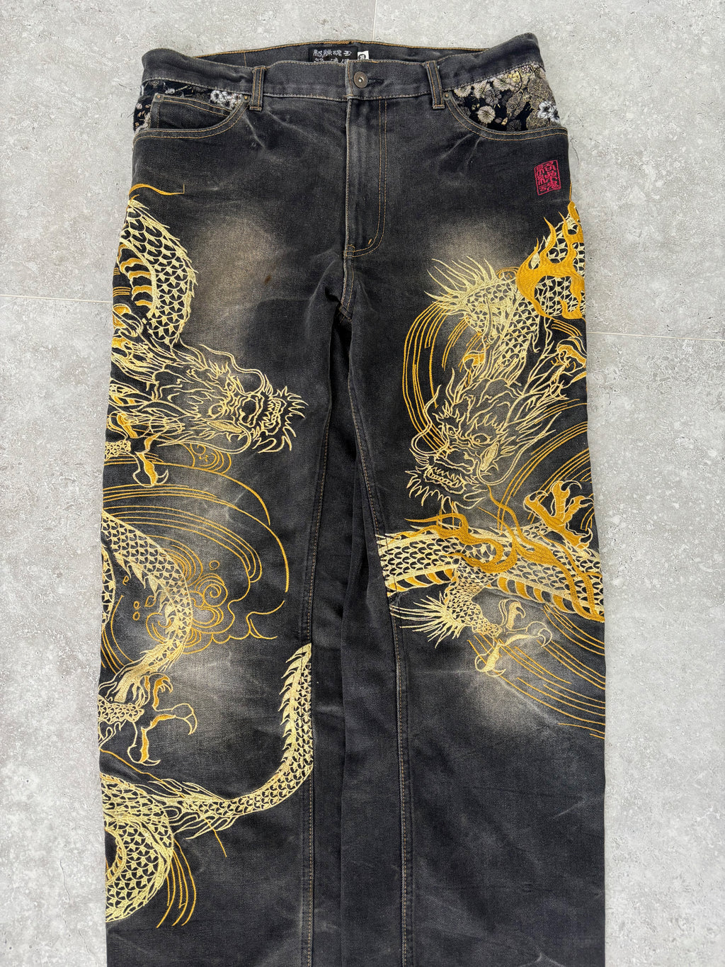 Karakuri black tab jeans with full dragon embroidery. Size 34–36.