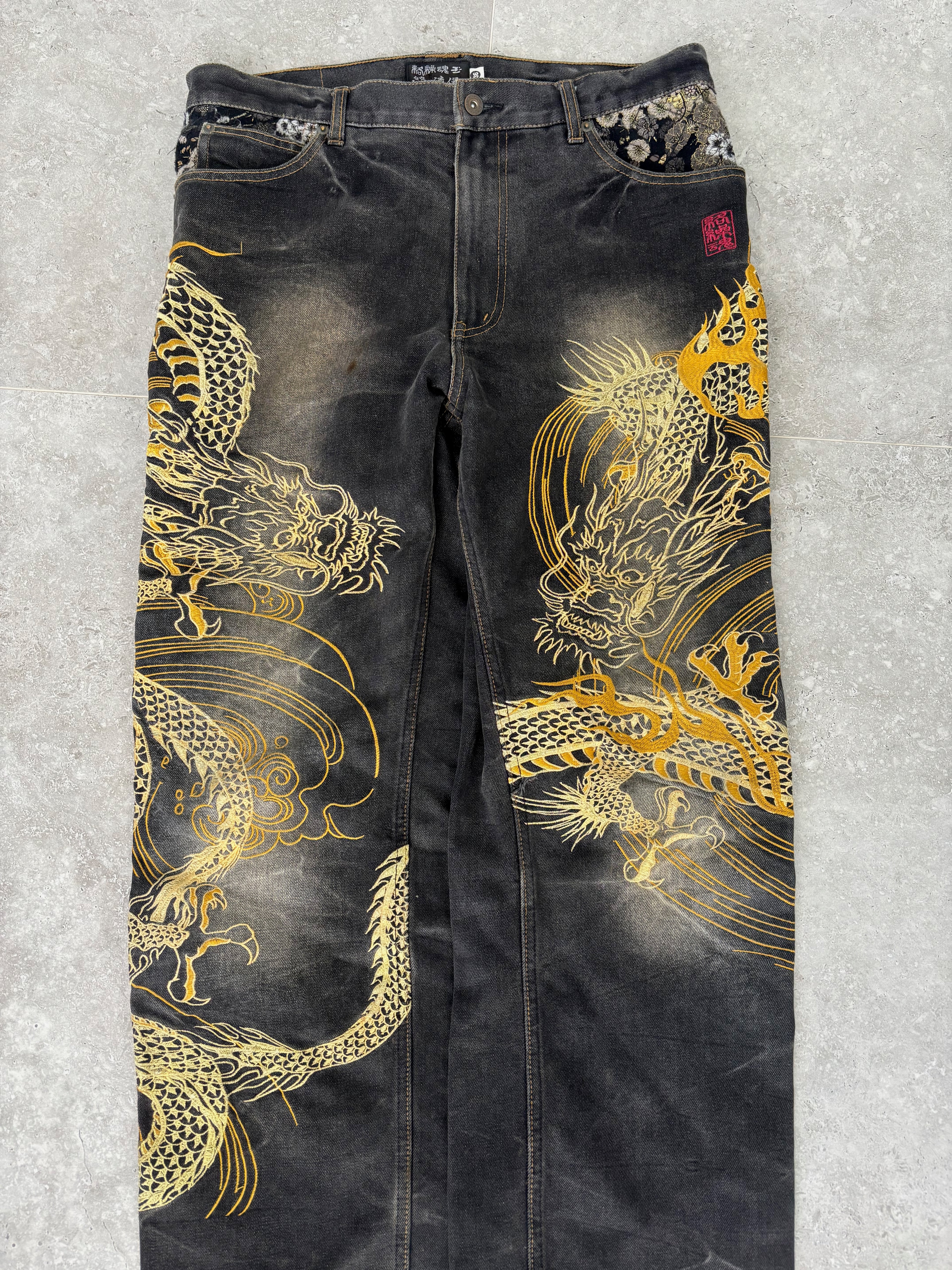 Karakuri black tab jeans with full dragon embroidery. Size 34–36.