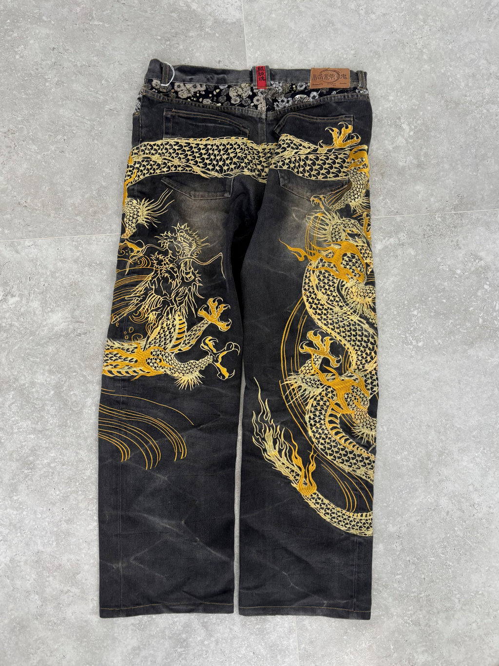 Karakuri black tab jeans with full dragon embroidery. Size 34–36.