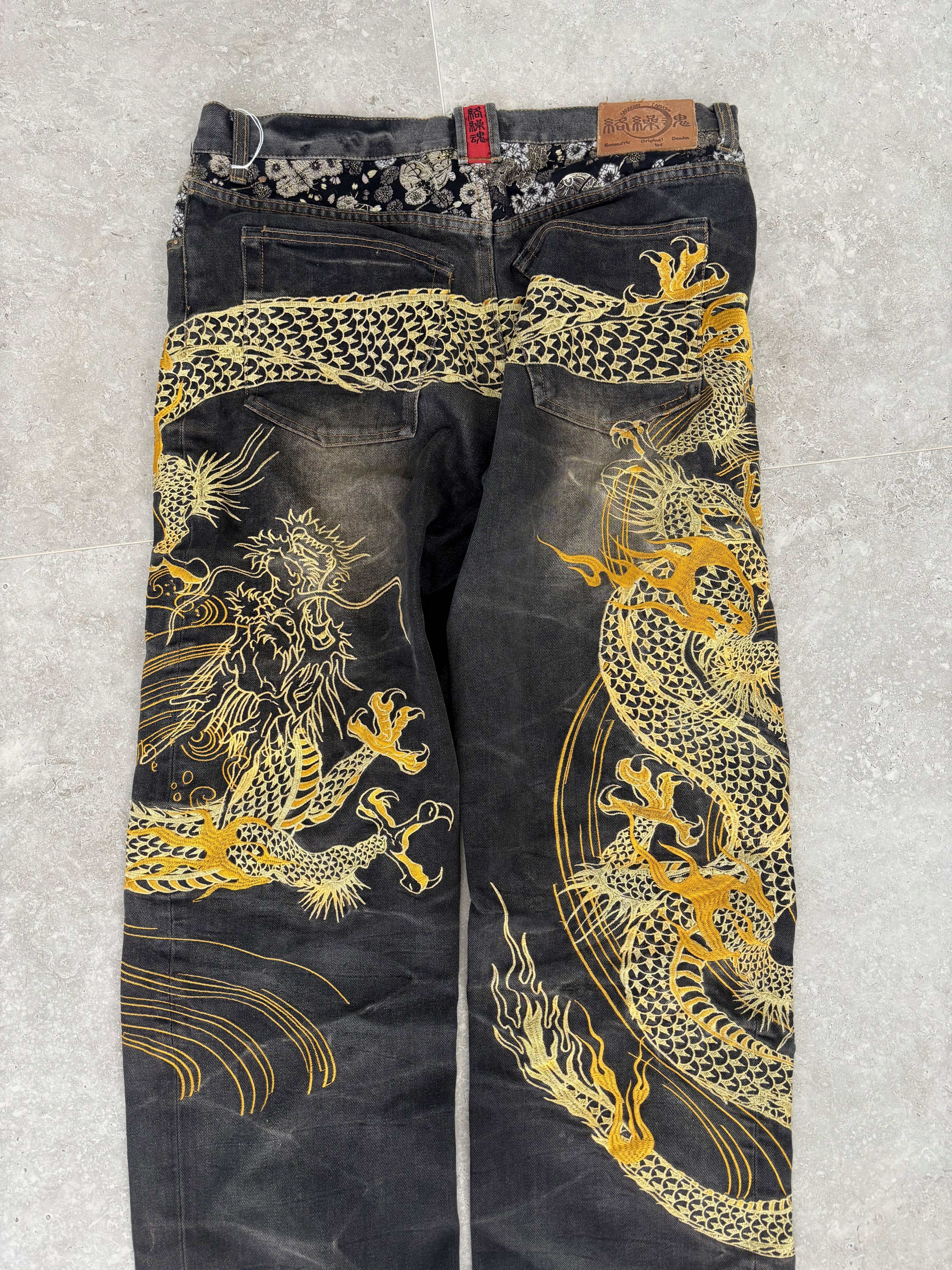 Karakuri black tab jeans with full dragon embroidery. Size 34–36.